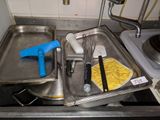 a pan with eggs, a whisk, a whisk and a whisk in it on a kitchen counter