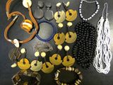 a lot of necklaces and bracelets that are on a table