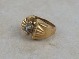 an image of a close up of a gold ring with a diamond