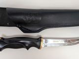 a knife that is laying next to a leather sheath