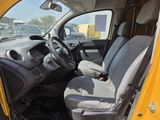 a yellow truck with a black seat in the back of it
