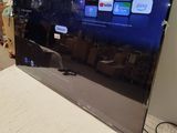 a flat screen tv sitting on top of a bed in a room