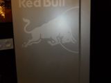 a refrigerator with a red bull logo on it