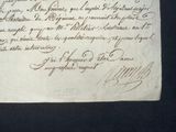an old document with writing on it on a black surface