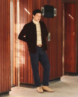 a man that is standing in front of a building