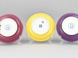 three different colored plates with buttons on them sitting on a table