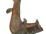 a bronze statue of a bird with a crown on it ' s head