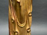 golden statue of a person with a hat and a robe on