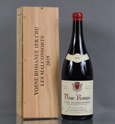 a bottle of wine sitting next to a wooden box
