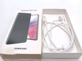 a box with a phone inside of it on a white surface