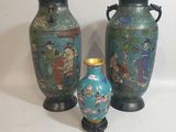 three vases sitting next to each other on a table