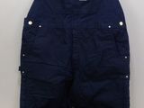 an image of a pair of overalls hanging on a hanger