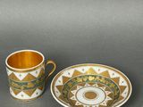 two cups and a saucer are sitting on a table