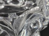a clear glass vase with a flower inside of it
