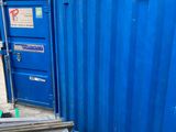 a blue container sitting in the middle of a parking lot