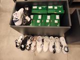 many pairs of shoes that are sitting on the floor