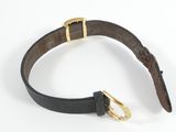 a close up of a black leather belt with a gold buckle