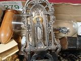 a small statue of jesus on top of a pile of other items