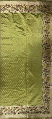 an image of a green table cloth with a floral border