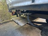 a truck that has a flat bed on the back of it