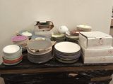 a table with many plates and bowls on it