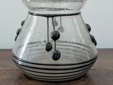 a glass vase that is sitting on a wooden table