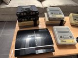 a coffee table with a bunch of game consoles on top of it