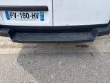 the rear end of a white van parked on the side of the road
