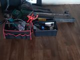 hardwood flooring with a bunch of tools on it and a plant in the corner