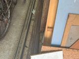 a pile of junk in a garage with a bike in the background