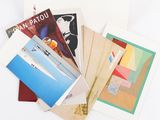 a pile of assorted postcards on a white surface