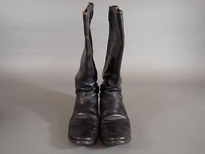 pair of black leather boots with zippers on them on a white surface