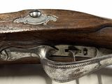 a close up of a gun on a white surface