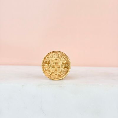 a gold coin sitting on top of a white counter
