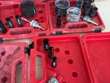 many tools in a red case sitting on a table
