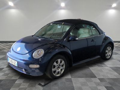 a picture of a blue volkswagen beetle parked in a garage