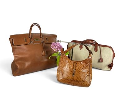 three pieces of purses are lined up on a white surface