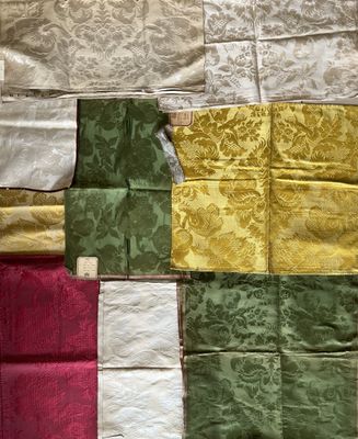 many pieces of fabric laid out on a table