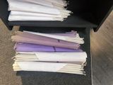 a lot of papers that are sitting on a shelf