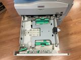 a printer that is sitting in a drawer on the floor