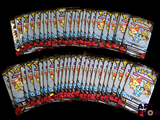 Plusieurs paquets de cartes à collectionner Pokémon sont empilés les uns sur les autres.