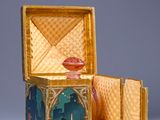 a small box with a painting on it sitting on a table