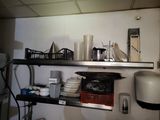 a shelf with dishes and cups on it in a kitchen