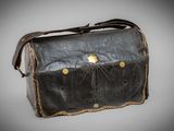 an old black leather bag with a gold star on it