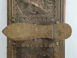 a metal door with a wooden handle and a plaque on it