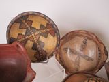 many different types of vases on display in a room