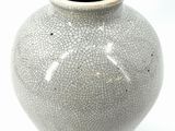 a white vase with a cracky design on it