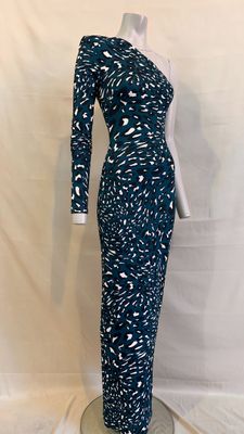 a woman ' s dress on a mannequin stand against a white backdrop