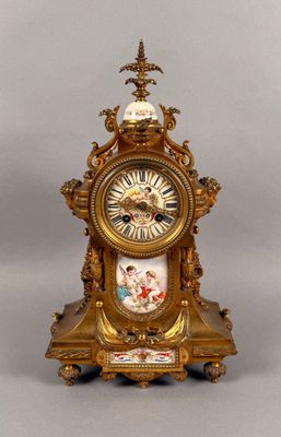 a gold clock that is sitting on a table