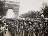 a lot of men in uniform marching down the street